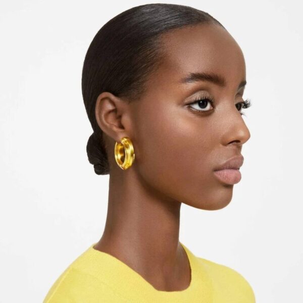 Close-up of yellow gold aluminum Swarovski hoop earrings with crystal details