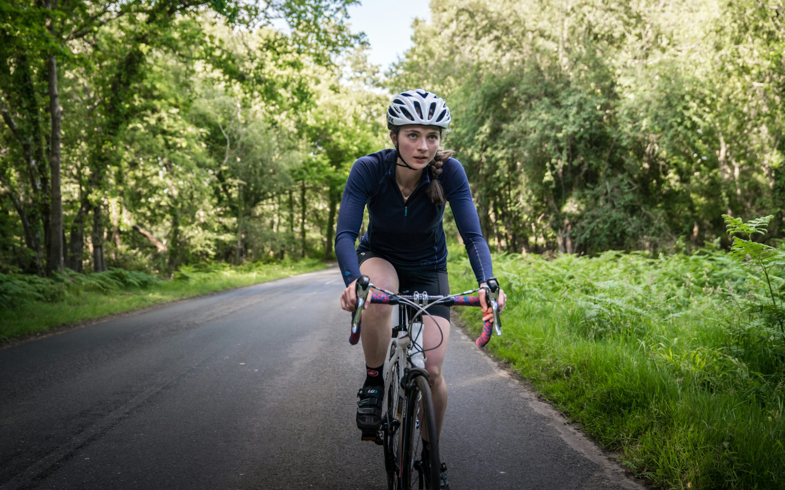 biker shorts women riding road bike in athletic activewear