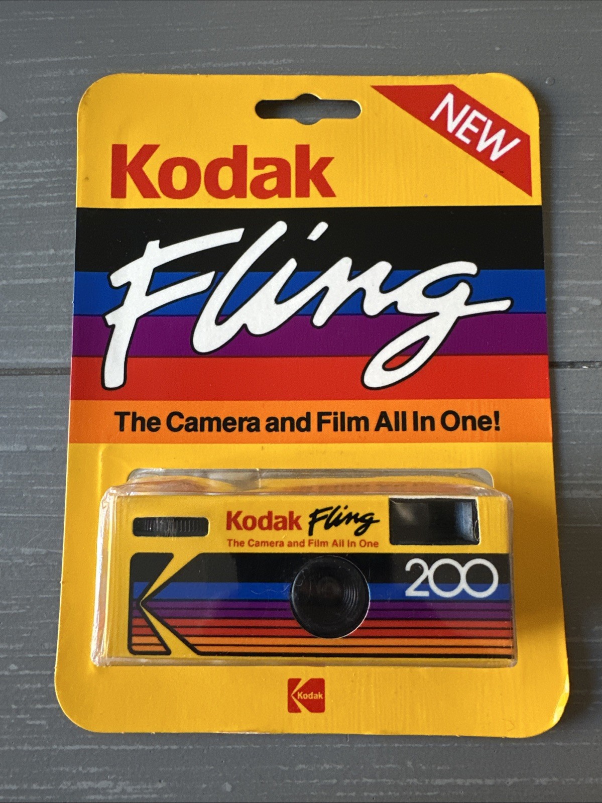 Kodak disposable camera on a wooden table with film roll – classic film photography for nostalgic photo lovers