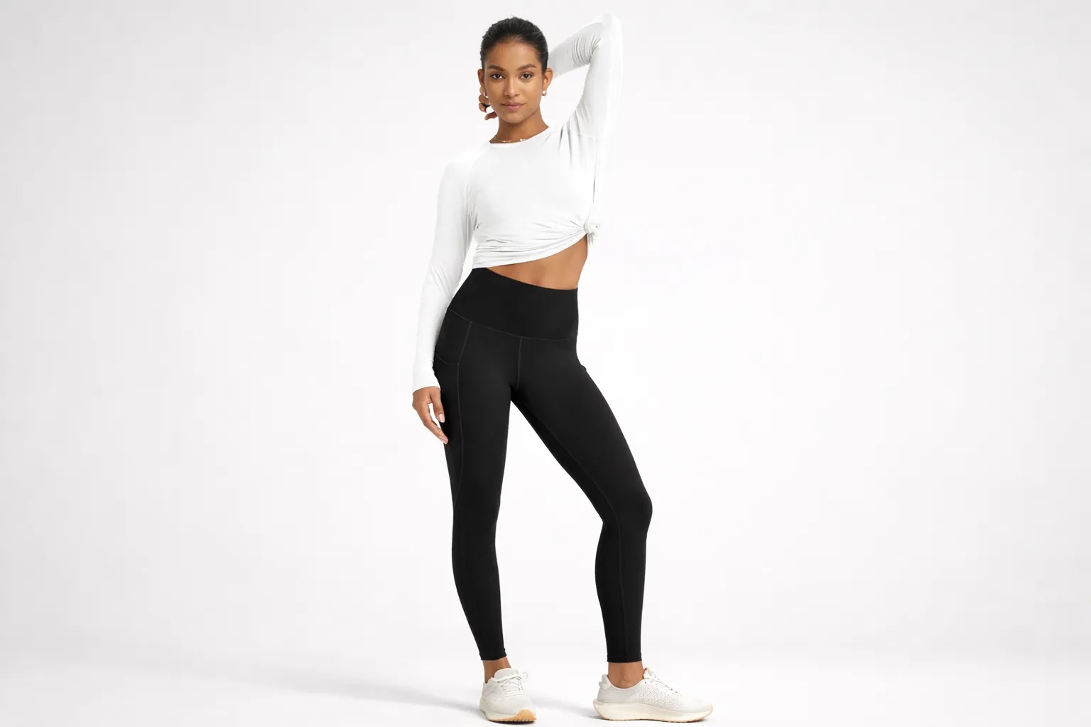 Model wearing squat proof leggings with high-waist fit and opaque fabric during a studio workout pose